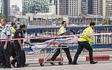 ZAKA volunteers remove the body of a Palestinian shot dead after carrying out a stabbing attack in Tel Aviv on October 8, 2015. (AFP/Jack Guez)