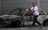 A Palestinian protester prepares to throw a firebomb during clashes with Israeli security forces in the Shuafat refugee camp in East Jerusalem, on October 9, 2015. (Ahmad Gharabli/AFP)