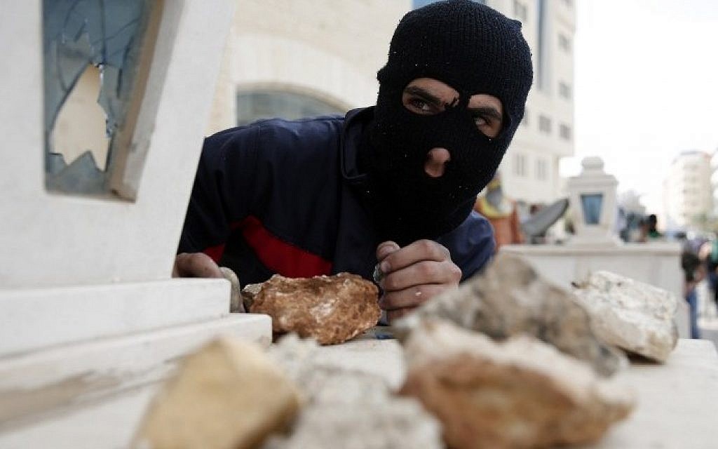 A Palestinian stone thrower looks on during clashes with Israeli security forces in Beit El, near the West Bank city of Ramallah on October 10, 2015. (AFP/ABBAS MOMANI)