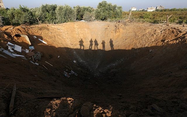 A picture taken on October 11, 2015 in the Zeitun sector south of Gaza City allegedly shows the crater left by an Israeli retaliatory air strike. (AFP/MAHMUD HAMS) A picture taken on October 11, 2015 in the Zeitun sector south of Gaza City allegedly shows the crater left by an Israeli retaliatory air strike. (AFP/MAHMUD HAMS)