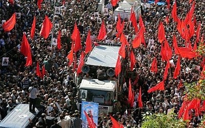 Illustrative: Iranians follow a vehicle carrying the coffin of Iran's Revolutionary Guards Corps Brigadier General Hossein Hamedani during his funeral procession in Tehran on October 11, 2015. (AFP/Atta Kenare)