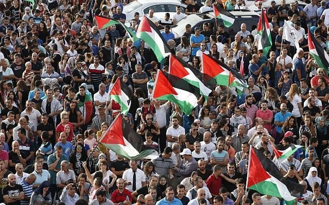 Arab Israelis, some holding Palestinian flags, take part in a large demonstration as part of a general strike organized to support the Palestinians on October 13, 2015 in the northern Arab-Israeli town of Sakhnin (AFP PHOTO/JACK GUEZ) Arab Israelis, some holding Palestinian flags, take part in a large demonstration as part of a general strike organized to support the Palestinians on October 13, 2015 in the northern Arab-Israeli town of Sakhnin (AFP PHOTO/JACK GUEZ)