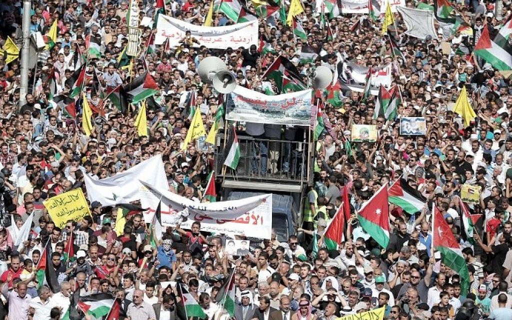 Jordanian protesters wave the national and Palestinian flags during a demonstration near the Israeli Embassy in the capital Amman in solidarity with the Palestinians on October 16, 2015. (Khalil Mazraawi/AFP) Jordanian protesters wave the national and Palestinian flags during a demonstration near the Israeli Embassy in the capital Amman in solidarity with the Palestinians on October 16, 2015. (Khalil Mazraawi/AFP)