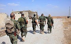 Syrian regime soldiers walk down a road in an area around Kweyris military airport, in the eastern Aleppo province on October 16, 2015. (AFP/George Ourfalian)
