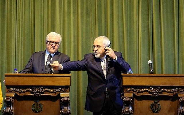 Iranian Foreign Minister Mohammad Javad Zarif (R) adjusts the microphone for his German counterpart Frank-Walter Steinmeier during a joint press conference in Tehran on October 17, 2015. (AFP PHOTO/ATTA KENARE) Iranian Foreign Minister Mohammad Javad Zarif (R) adjusts the microphone for his German counterpart Frank-Walter Steinmeier during a joint press conference in Tehran on October 17, 2015. (AFP PHOTO/ATTA KENARE)