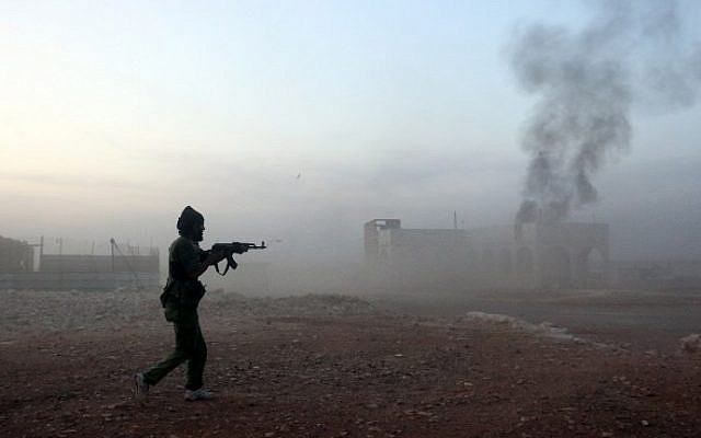 A picture taken on October 17, 2015 shows smoke billowing as a Syrian opposition fighter fires a weapon in the Mount Azzan area, 24 kms from the northern Syrian city of Aleppo, during reported fighting against forces loyal to Syrian President Bashar Assad. (AFP PHOTO/THAER MOHAMMED) A picture taken on October 17, 2015 shows smoke billowing as a Syrian opposition fighter fires a weapon in the Mount Azzan area, 24 kms from the northern Syrian city of Aleppo, during reported fighting against forces loyal to Syrian President Bashar Assad. (AFP PHOTO/THAER MOHAMMED)