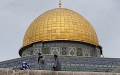 Palestinian girls sit in front of the Dome of the Rock in the Temple Mount compound on October 23, 2015. (AFP/Ahmad Gharabli)