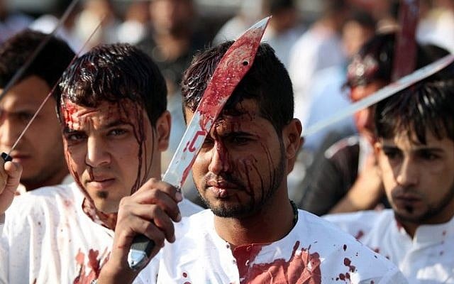 Iraqi men take part in a self-flagellation procession on the tenth day of the mourning period of Muharram, which marks the day of Ashura on October 24, 2015, in Baghdad's northern district of Kadhimiya. (AFP PHOTO/AHMAD AL-RUBAYE) Iraqi men take part in a self-flagellation procession on the tenth day of the mourning period of Muharram, which marks the day of Ashura on October 24, 2015, in Baghdad's northern district of Kadhimiya. (AFP PHOTO/AHMAD AL-RUBAYE)