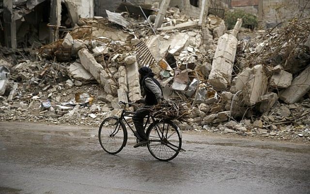 A Syrian man rides a bike past damaged buildings in the rebel-held area of Douma, east of the capital Damascus, on October 25, 2015. (AFP PHOTO / SAMEER AL-DOUMY) A Syrian man rides a bike past damaged buildings in the rebel-held area of Douma, east of the capital Damascus, on October 25, 2015. (AFP PHOTO / SAMEER AL-DOUMY)