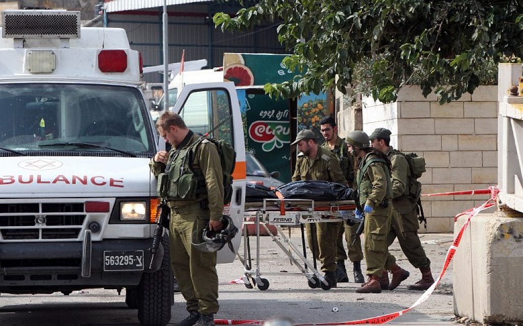 Israeli soldiers evacuate, on a stretcher, the body of Palestinian Raed Jarradat, who had stabbed and seriously wounded a soldier before he was shot dead, on Monday, October 26, 2015, near the West Bank city of Hebron (AFP PHOTO/HAZEM BADER) Israeli soldiers evacuate, on a stretcher, the body of Palestinian Raed Jarradat, who had stabbed and seriously wounded a soldier before he was shot dead, on Monday, October 26, 2015, near the West Bank city of Hebron (AFP PHOTO/HAZEM BADER)
