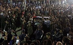 File: Palestinians gather in Hebron as PA security forces carry the bodies of two out of five Palestinians assailants released by Israel on October 30, 2015. (AFP Photo/Hazem Bader)