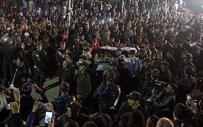 File: Palestinians gather in Hebron as PA security forces carry the bodies of two out of five Palestinians assailants released by Israel on October 30, 2015. (AFP Photo/Hazem Bader)