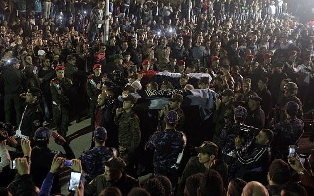 File: Palestinians gather in Hebron as PA security forces carry the bodies of two out of five Palestinians assailants released by Israel on October 30, 2015. (AFP Photo/Hazem Bader) File: Palestinians gather in Hebron as PA security forces carry the bodies of two out of five Palestinians assailants released by Israel on October 30, 2015. (AFP Photo/Hazem Bader)