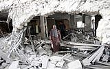 A Palestinian woman walks amid the rubble of a house after Israeli security forces demolished the homes of two Palestinians behind attacks in the Palestinian neighborhood of Jabal Mukaber in East Jerusalem, on October 6, 2015. (AFP/THOMAS COEX)