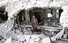 Illustrative photo of a Palestinian woman walking amid the rubble of a house after Israeli security forces demolished the homes of two Palestinians behind attacks in the Palestinian neighborhood of Jabal Mukaber in East Jerusalem, on October 6, 2015. (AFP/THOMAS COEX)