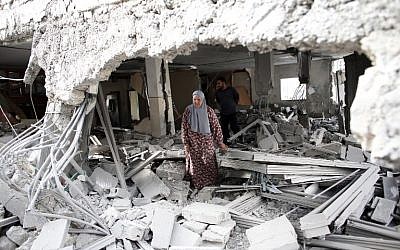 Illustrative photo of a Palestinian woman walking amid the rubble of a house after Israeli security forces demolished the homes of two Palestinians behind attacks in the Palestinian neighborhood of Jabal Mukaber in East Jerusalem, on October 6, 2015. (AFP/THOMAS COEX)