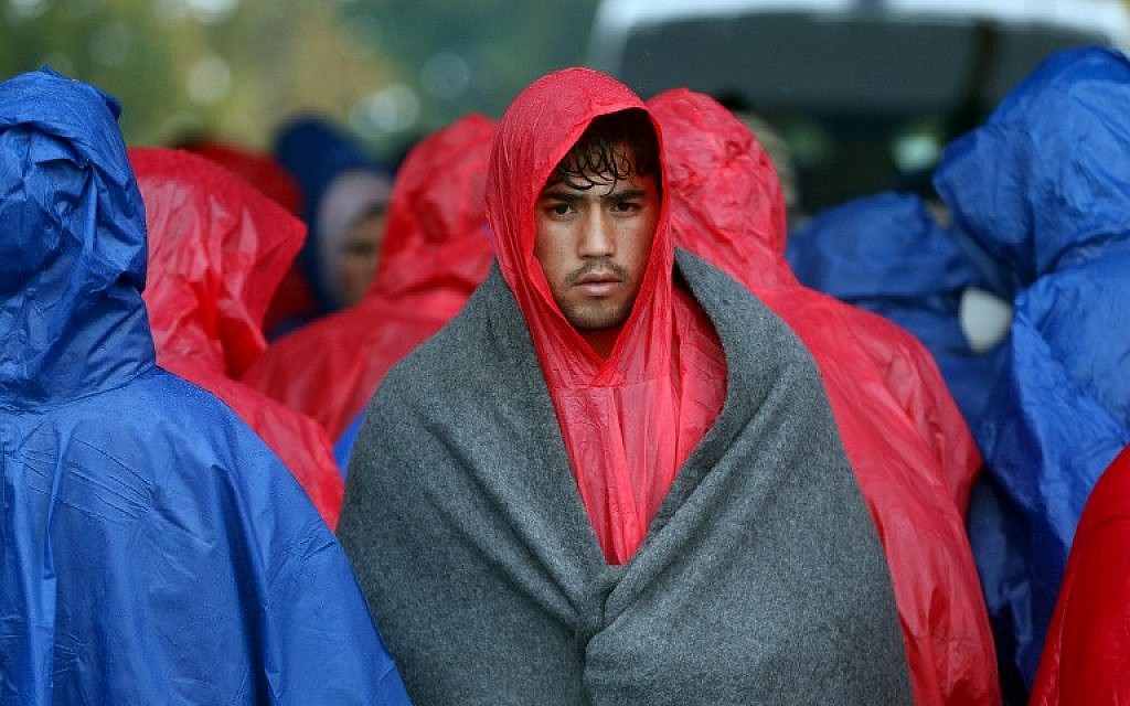 Migrants and refugees wait in the rain as they wait to enter Slovenia, at the Croatian-Slovenian border in Trnovec, on October 19, 2015. (AFP) Migrants and refugees wait in the rain as they wait to enter Slovenia, at the Croatian-Slovenian border in Trnovec, on October 19, 2015. (AFP)
