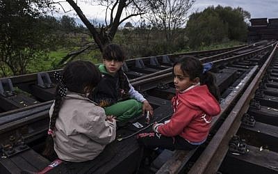 Migrant girls sit on railway tracks as migrants and refugees wait for a train after crossing the Macedonian-Serbian border near the town of Bujanovac on October 23, 2015. (AFP/ ARMEND NIMANI)