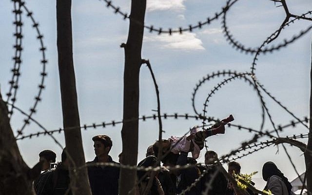 Migrants and asylum seekers cross the Greek-Macedonian border near Gevgelija, on October 2, 2015. (AFP/ ARMEND NIMANI)