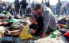 An injured woman is comforted following an explosion at the main train station in Turkey's capital, Ankara, on October 10, 2015. (AFP/Ozcan Yaman)