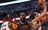 LeBron James of the Cleveland Cavaliers complains to a referee as he is trapped between Jimmy Butler and Joakim Noah of the Chicago Bulls during the season opening game at the United Center on October 27, 2015 in Chicago, Illinois. (Jonathan Daniel/Getty Images/AFP)