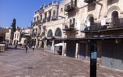 The entrance to the Souk of the Old City in Jerusalem on Sunday, October 4, 2015. The street, usually bustling with tourists, are almost deserted, after the government decided in an unprecedented step to ban entry to Palestinians who are not residents of the city. Other store owners closed down shop in protest at the move. (Tamar Pileggi/The Times of Israel)