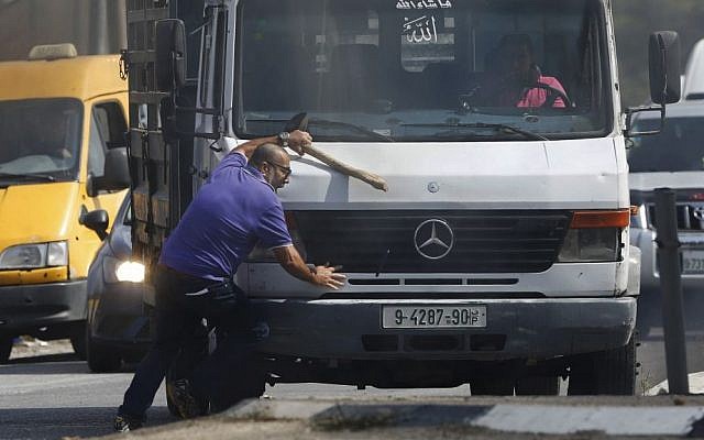 Avraham Hasano is hit by a truck driven by a Palestinian man at Fawar junction near the West Bank city of Hebron on Tuesday, October 20, 2015. Hasano had gotten out from his car after it was it by Palestinian ston throwers. He was run over by the truck and later died (AP Photo/Nasser Shiyoukhi)