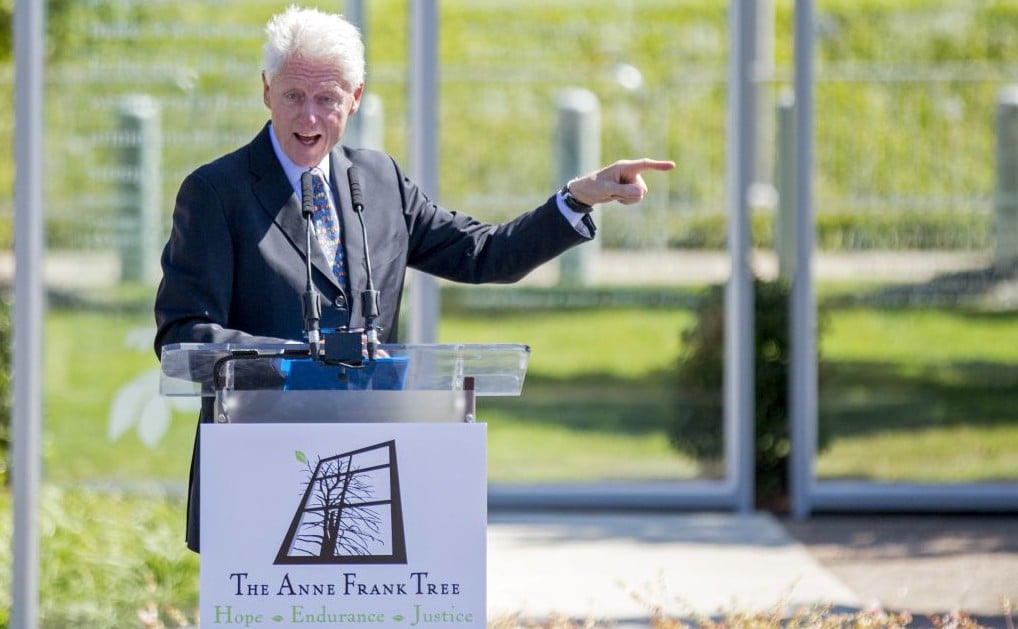 Former US president Bill Clinton speaks at the grand opening of an installation outside his presidential library honoring Anne Frank, Oct. 2, 2015, in Little Rock, Arkansas. The installation features a sapling from a tree outside the building where she and her family hid from the Nazis during World War II. (AP Photo/Gareth Patterson) Former US president Bill Clinton speaks at the grand opening of an installation outside his presidential library honoring Anne Frank, Oct. 2, 2015, in Little Rock, Arkansas. The installation features a sapling from a tree outside the building where she and her family hid from the Nazis during World War II. (AP Photo/Gareth Patterson)