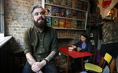 Alan Keery one of the twin brothers who developed and own the Cereal Killer Cafe in Brick Lane, London on Wednesday, September 30, 2015. (Alastair Grant/AP)