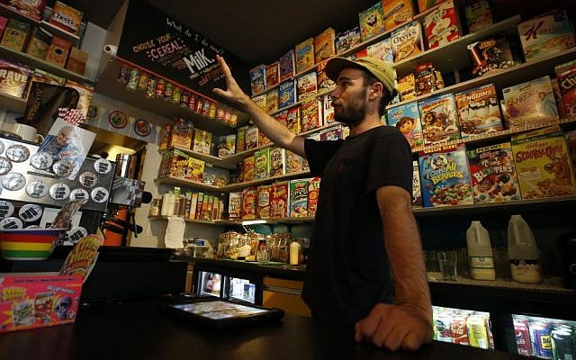 An employee shows costumers the selection at the Cereal Killer Cafe in Brick Lane, London, Wednesday, September 30, 2015. (Alastair Grant/AP) An employee shows costumers the selection at the Cereal Killer Cafe in Brick Lane, London, Wednesday, September 30, 2015. (Alastair Grant/AP)