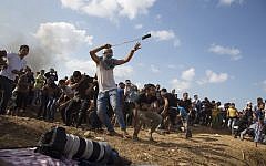 Illustrative photo of a Palestinian protester hurling stones at Israeli soldiers during clashes on the Israeli border in eastern Gaza City, October 9, 2015. (AP/Adel Hana)