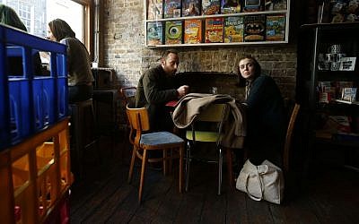 Customers Peter Huston and Mia Johns enjoy the atmosphere as they eat their selection at Cereal Killer Cafe in Brick Lane London Wednesday, September, 30, 2015. (Alastair Grant/AP)