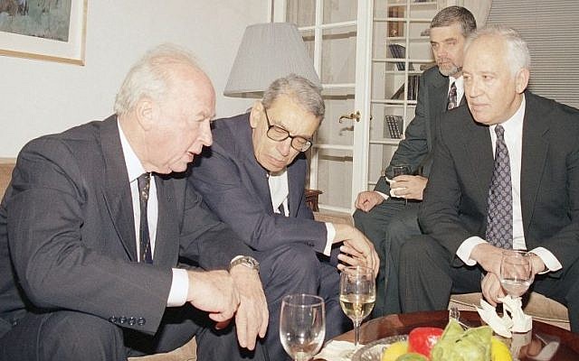 Israeli prime minister Yitzhak Rabin, left, with United Nations secretary general Boutros Boutros-Ghali and Gad Yaacobi, right, Israel's UN ambassador on Friday, November12, 1993, at Yaacobi's residence in New York. Shimon Sheves, behind Yaacobi, the director of the Prime Minister's office, listens in. (AP Photo/David Karp)