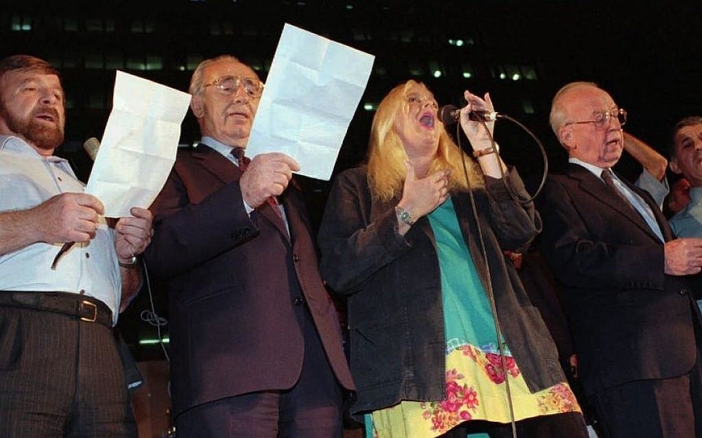 The night of the murder: (From right) Prime minister Yitzhak Rabin, Miri Aloni, foreign minister Shimon Peres and Knesset speaker Shevah Weiss sing a Song for Peace at the end of a rally in Tel Aviv on Saturday, November 4, 1995. Rabin was assassinated as he left the rally minutes later. (AP photo) The night of the murder: (From right) Prime minister Yitzhak Rabin, Miri Aloni, foreign minister Shimon Peres and Knesset speaker Shevah Weiss sing a Song for Peace at the end of a rally in Tel Aviv on Saturday, November 4, 1995. Rabin was assassinated as he left the rally minutes later. (AP photo)