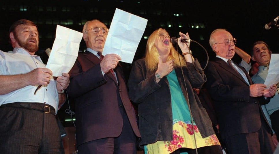 The night of the murder: (From right) Prime minister Yitzhak Rabin, Miri Aloni, foreign minister Shimon Peres and Knesset speaker Shevah Weiss sing a Song for Peace at the end of a rally in Tel Aviv on Saturday, November 4, 1995. Rabin was assassinated as he left the rally minutes later. (AP photo) The night of the murder: (From right) Prime minister Yitzhak Rabin, Miri Aloni, foreign minister Shimon Peres and Knesset speaker Shevah Weiss sing a Song for Peace at the end of a rally in Tel Aviv on Saturday, November 4, 1995. Rabin was assassinated as he left the rally minutes later. (AP photo)