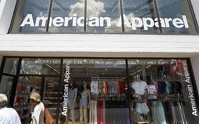 In this Wednesday, July 9, 2014, file photo, passers-by walk in front of the American Apparel store in the Shadyside neighborhood of Pittsburgh. (AP/Keith Srakocic, File)