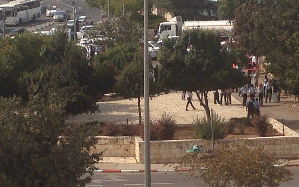 Police officers and civilians are seen at the scene of a stabbing attack in northern Jerusalem, on Monday October 12, 2015. (Israel Police)