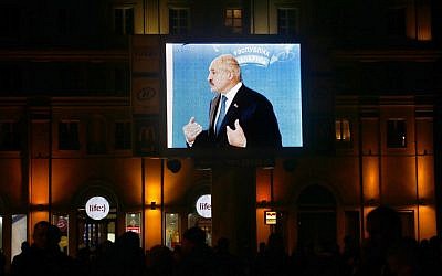 Belarusian President Alexander Lukashenko is seen on a large screen, speaking to media at a polling station after voting during presidential elections in Minsk, Belarus, late Sunday, October 11, 2015. (Photo by AP Photo/Sergei Grits)