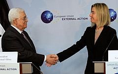European Union High Representative Federica Mogherini, right, shakes hands with Palestinian Authority President Mahmoud Abbas prior to a meeting at the EU External Action Service building in Brussels on Monday, Oct. 26, 2015. (AP/Francois Walschaerts)