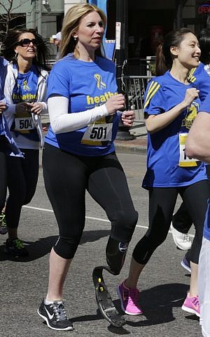 In this April 19, 2014, file photo, Boston Marathon bombing survivor Heather Abbott, center, dashes from the start line on her running blade during the Tribute Run during Boston Marathon weekend in Boston. (AP Photo/Charles Krupa, File) In this April 19, 2014, file photo, Boston Marathon bombing survivor Heather Abbott, center, dashes from the start line on her running blade during the Tribute Run during Boston Marathon weekend in Boston. (AP Photo/Charles Krupa, File)