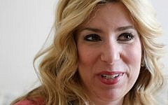 In this March 20, 2014, file photo, Boston Marathon bombing survivor Heather Abbott speaks with a reporter at her home in Newport, Rhode Island. (AP Photo/Steven Senne, File)