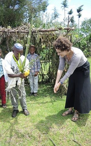 Showing some of the children how to shake the lulav and etrog for the first time. I was worried about teaching them the wrong order or incorrect practices. (Melanie Lidman/Times of Israel)