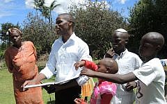 Yehudah Kimani, left, has utilized Facebook to reach out to Jews around the world. The self-taught social media maven, pictured here on October 4, 2015, hopes to offer computer classes to Jewish and non-Jewish children in his rural Kenyan village. (Melanie Lidman/Times of Israel)