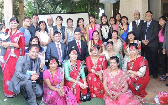 Nepalese Ambassador to Israel Prahlad Kumar Prasai (in the center, with a black hat and red tie) hosts Nepalis living in Israel at his residence in Herziliya for Dashain celebrations on October 22. Tamang skipped the festivities so he could go to the Dead Sea, though he visited Ambassador Prasai later that evening. (Melanie Lidman/Times of Israel)