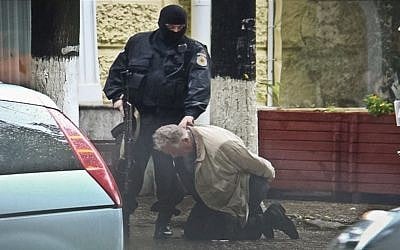 Teodor Chetrus is detained by a police officer in Chisinau, Moldova during a uranium-235 sting operation, June 27, 2011. (Moldova Police via AP) Teodor Chetrus is detained by a police officer in Chisinau, Moldova during a uranium-235 sting operation, June 27, 2011. (Moldova Police via AP)