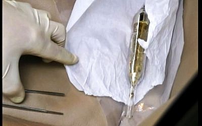 An investigator looks at a vial containing cesium-135 on the driver's seat of Valentin Grossu's car following his arrest in Chisinau, Moldova, In this February 19, 2015. (Moldova Police via AP) An investigator looks at a vial containing cesium-135 on the driver's seat of Valentin Grossu's car following his arrest in Chisinau, Moldova, In this February 19, 2015. (Moldova Police via AP)