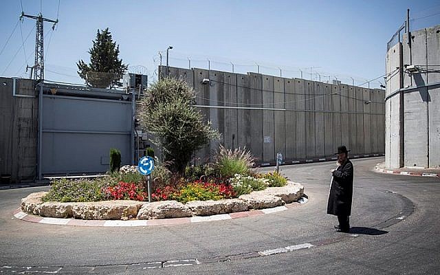 Illustrative: An Ultra Orthodox Jewish man stands by the intersection at the entrance to the Jewish religious site of Rachel's Tomb, surrounded by the Separation Wall, near Bethlehem, on June 26, 2014. (Hadas Parush/Flash90) Illustrative: An Ultra Orthodox Jewish man stands by the intersection at the entrance to the Jewish religious site of Rachel's Tomb, surrounded by the Separation Wall, near Bethlehem, on June 26, 2014. (Hadas Parush/Flash90)