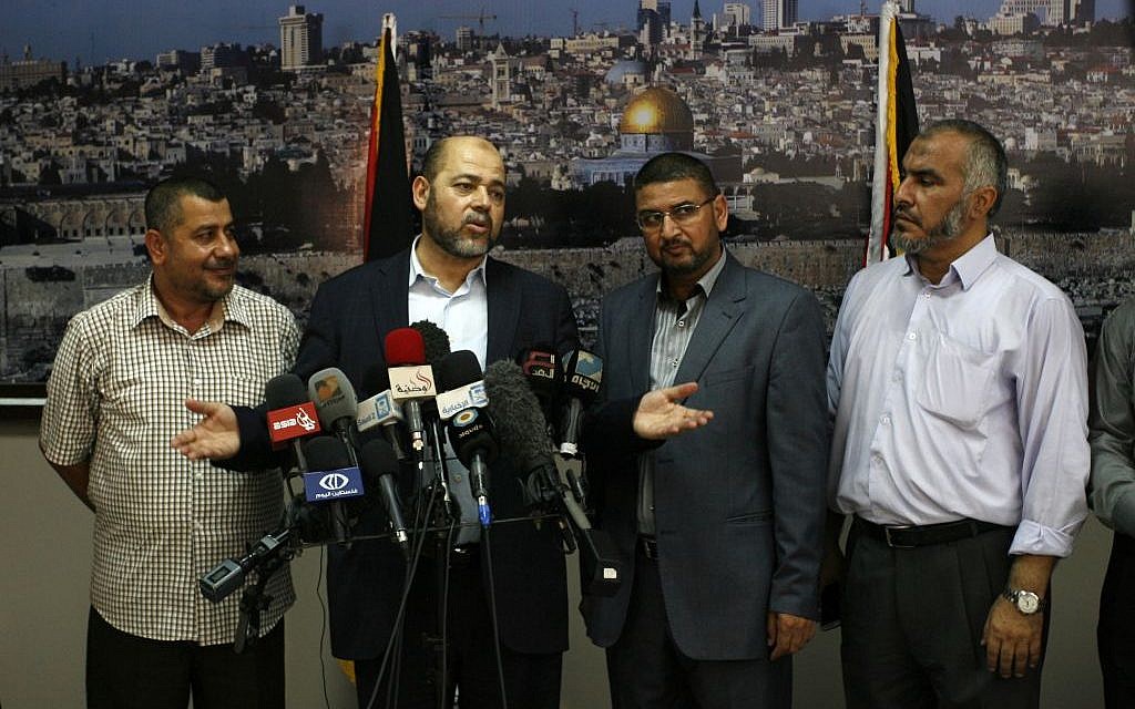 Senior Hamas official Moussa Abu Marzouk (second from left) speaks to media at the Rafah crossing in the southern Gaza Strip after negotiations in Cairo, August 28, 2014. (Abed Rahim Khatib/Flash90)