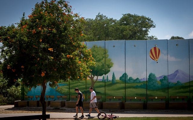 Israeli children play by a colorfully painted concrete protective shelter in the kibbutz of Nahal Oz. July 6, 2015. (Miriam Alster/FLASH90) Israeli children play by a colorfully painted concrete protective shelter in the kibbutz of Nahal Oz. July 6, 2015. (Miriam Alster/FLASH90)