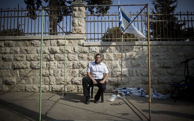 Yossi Dagan, head of the Samaria Regional Council, sits at a Sukka outside the Prime Minister's Residence in Jerusalem on October 2, 2015. Dagan announced that he was starting a hunger strike protest in the wake of the murder of Israeli couple, Naama and Eitam Henkin, to demand what he called "an appropriate response" from Prime Minister Benjamin Netanyahu (Photo by Yonatan Sindel/Flash90)
